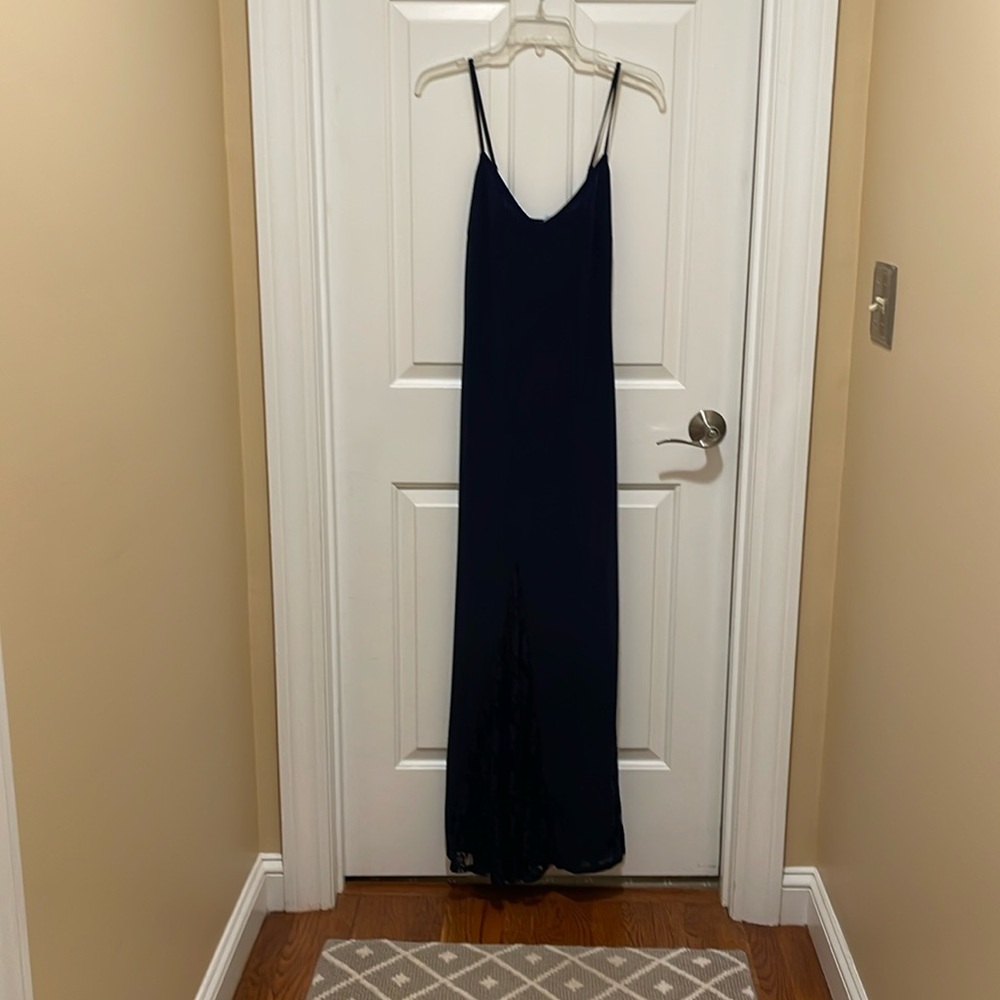 Long navy dress with spaghetti, straps and lace details at the bottom